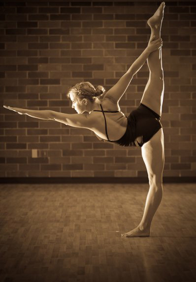 Bikram Hot Yoga Vancouver Director Erika Lasee holds the standing bow pulling pose.