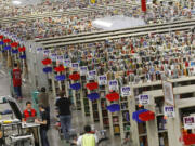 Workers push carts of merchandise at the Amazon.com Phoenix Fulfillment Center in 2010.