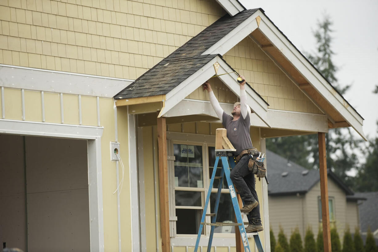 Lance Eppers, from Clearwater Construction, helps build a home in Ridgefield's Green Gables subdivision for Lennar Corp.