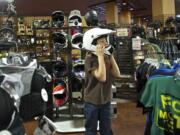 Conner Grant, 11, of Battle Ground tries on a helmet at Pro Caliber in Vancouver, one of three retail locations for the Vancouver-based company.