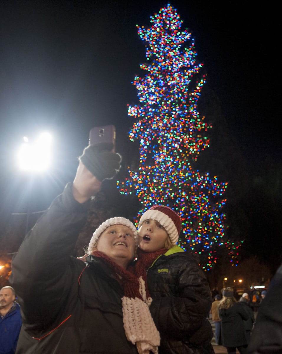 Beka Schueth and son Nathanael take a selfie as they attend the annual Christmas tree lighting event at Esther Short Park on Friday night.