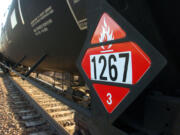 A warning placard on a tank car carrying crude oil is seen on a train idled on the tracks near a crude loading terminal in Trenton, N.D. on Nov. 6, 2013. The transport of oil by rail has expanded more than thirty-fold since 2009, delivering higher prices for oil companies able to access to coastal refineries but also raising concerns about spills.