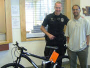 Battle Ground Police Officer Clint Fraser helped get Kishan &quot;Sam&quot; Aylor a bike after his was damaged when a vehicle crashed into him last month.