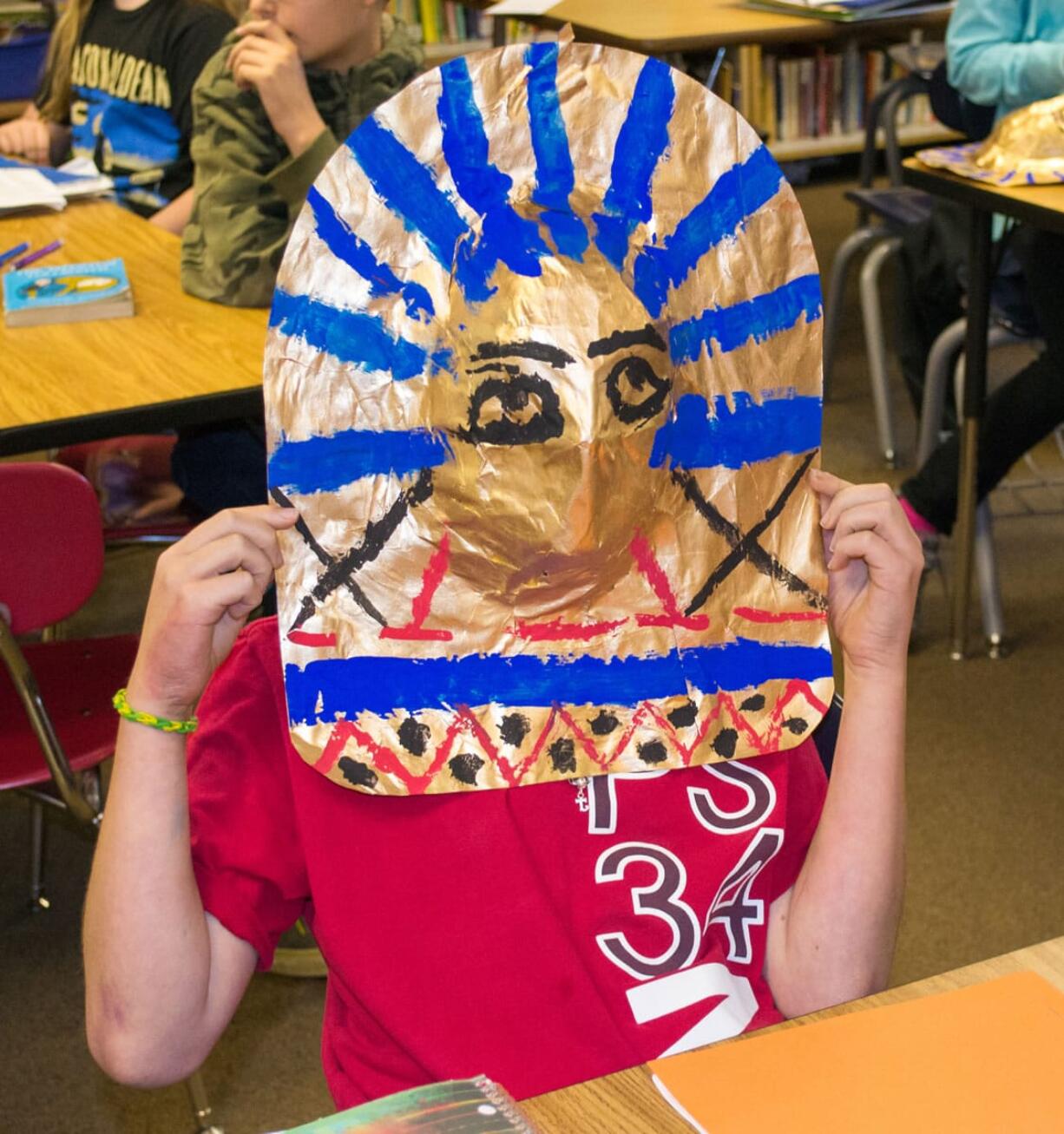 Ridgefield: Union Ridge Elementary School sixth-grader Jason Gasca puts on a mask he made during a recent class lesson on Egyptian history.