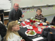 Battle Ground: Captain Strong Primary third-graders Emma Koppe, from left, Austin Lassiter, Felix Extrada and Ella Schlect eat a fancy four-course meal Dec.