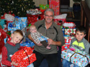 Bennington: Riverview Community Bank Executive Vice President Kim Capeloto and a few employees' children, Landen Whaley, from left, Zane Whaley and Austyn Konopasek, hold gifts in December that were gathered during the bank's annual donation drive for foster children.