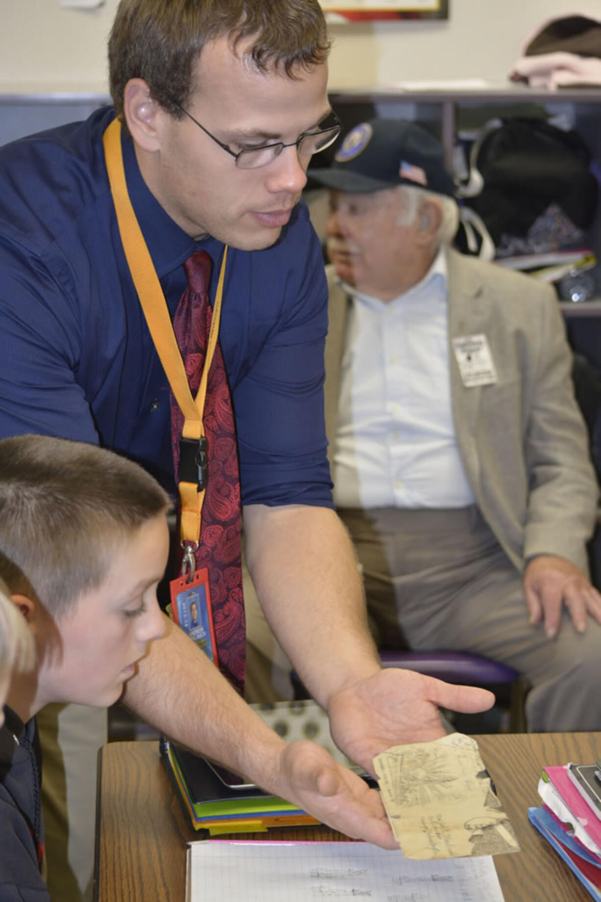 Washougal: Hathaway Elementary School fifth-grade teacher Andrew Schlauch shows students a historic envelope commemorating the Japanese surrender in World War II.