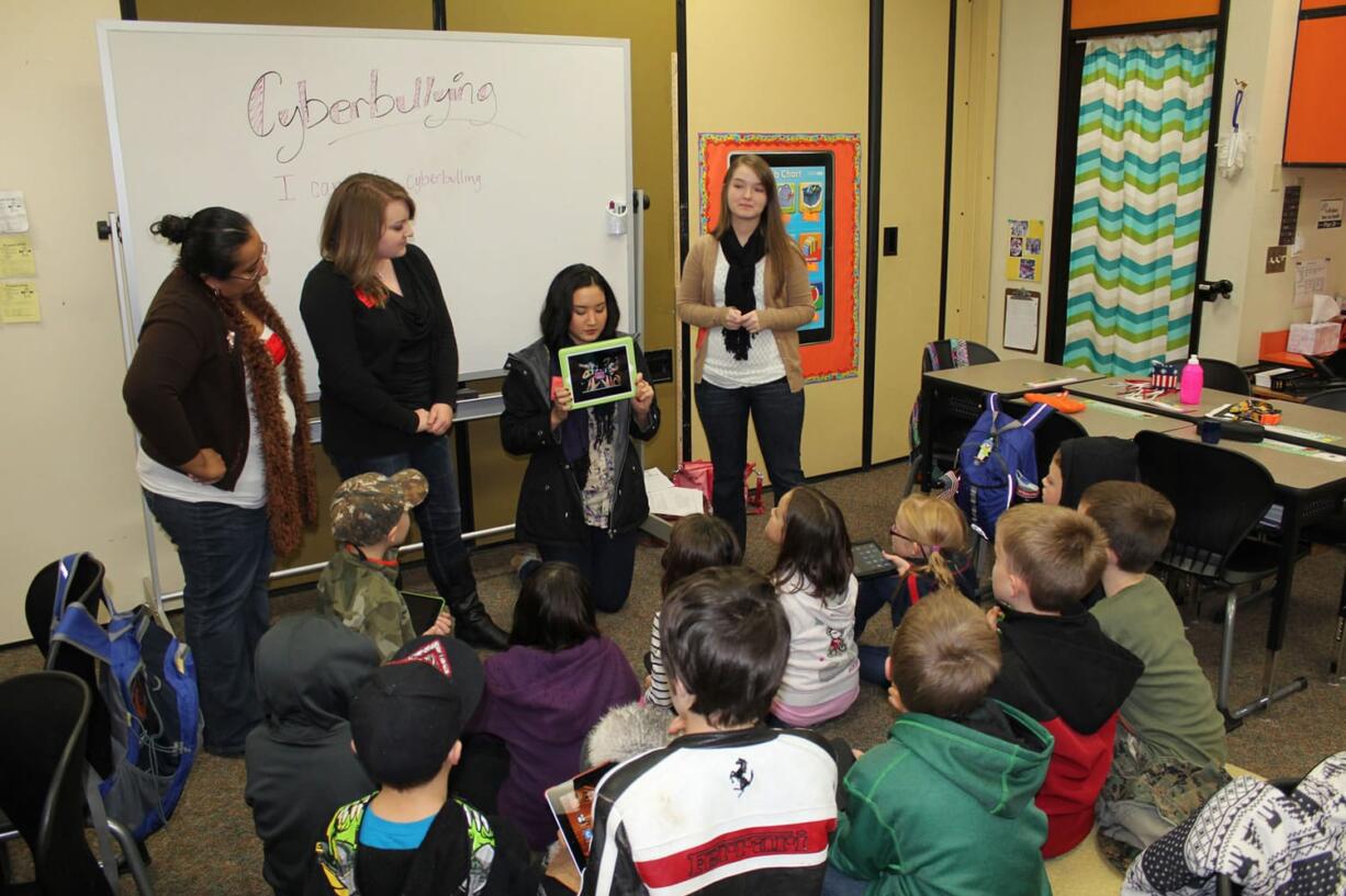 Pleasant Valley: Students in Teresa Taylor's third-grade class at Pleasant Valley Primary School watch an anti-bullying video on an iPad during a recent class lesson on Internet safety.