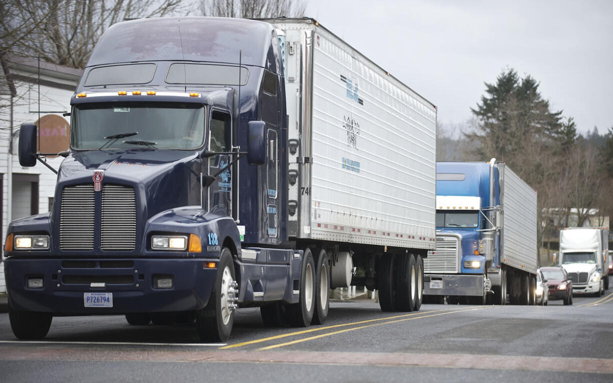 A parade of trucks rumbles down First Street in Stevenson on Friday afternoon.