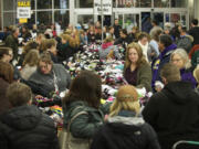 Shoppers at Salmon Creek's Fred Meyer store dig through piles of half-priced socks just after 5 a.m. on Friday, eager to take advantage of the store's Black Friday sale prices.