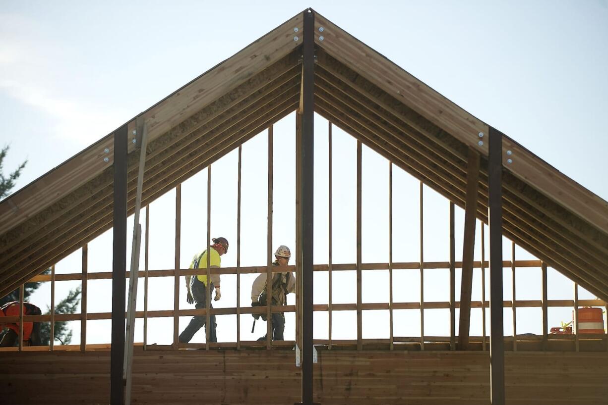 Construction workers walk high above what will be the new main entrance to Columbia Presbyterian Church, as construction continues on a major overhaul of the church to accommodate a growing congregation.