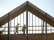 Construction workers walk high above what will be the new main entrance to Columbia Presbyterian Church, as construction continues on a major overhaul of the church to accommodate a growing congregation.