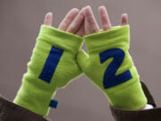 A Seattle Seahawks fan holds up 12th man gloves in support of the Seahawks before the start of the NFC Championship game at CenturyLink Field Sunday January 19, 2014 in Seattle, Washington.