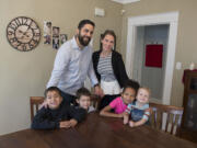 Zachery, top row from left, and Sarah Desjarlais pause for a portrait with their kids Anthony, 6, bottom row from left , Abe, 4, Avi, 6, and Atticus, 3.