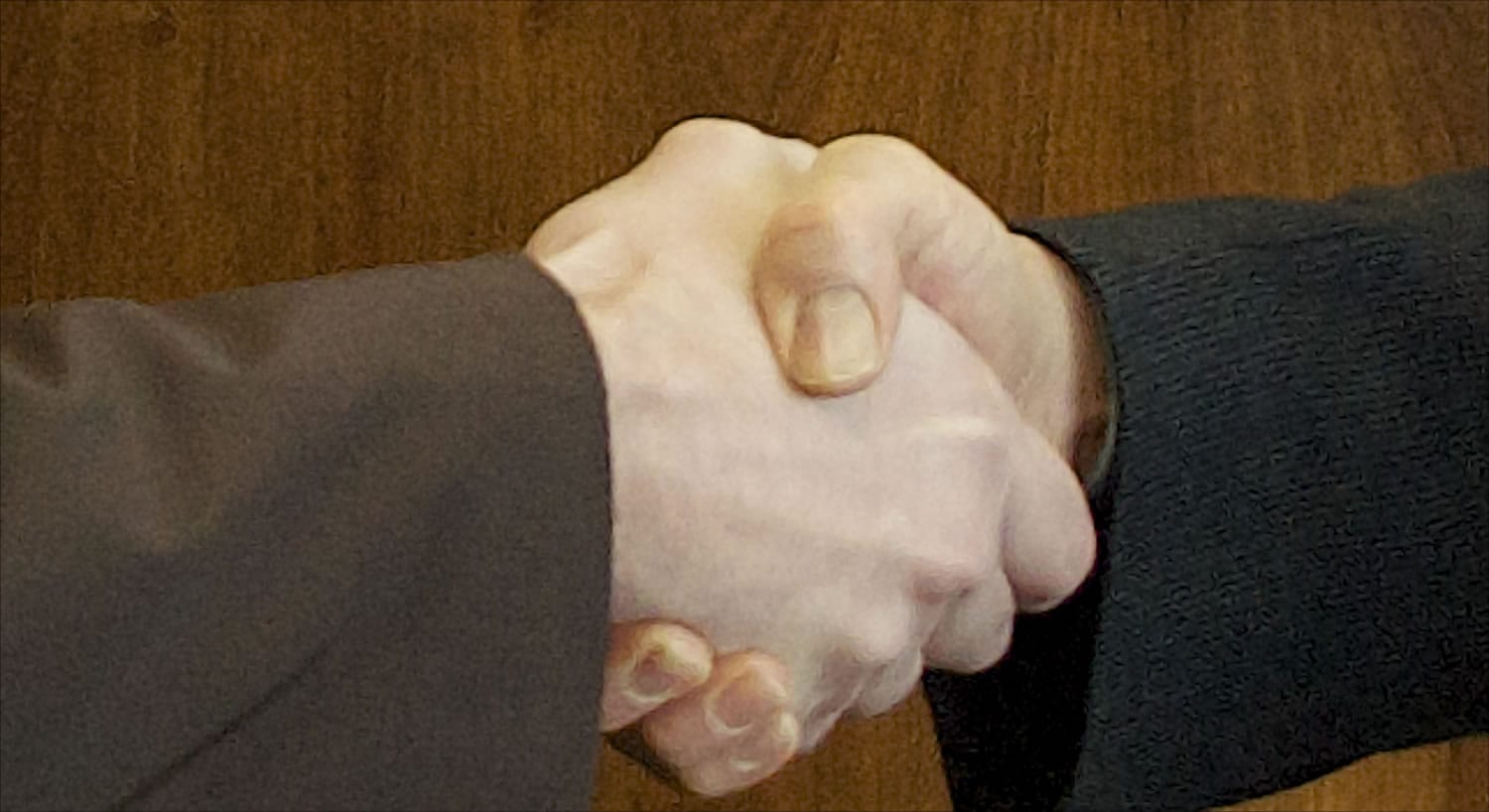 Clark County Commissioner David Madore, left, shakes hands with Vancouver Mayor Tim Leavitt while visiting before a conversation with The Columbian Editor Lou Brancaccio.