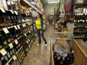 A shopper makes a liquor purchase at Total Wine &amp; More, among the spirit-selling newcomers that saw business potential opportunities in Clark County after a voter-approved measure privatized Washington's former state-run liquor system.