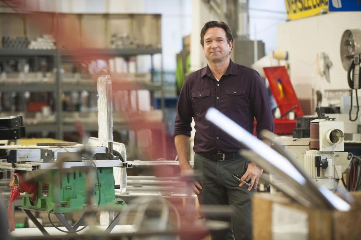 Sign designer Garrett Mattimoe stands in the workshop at the Vancouver Sign Group in Vancouver.