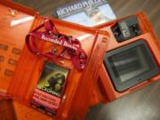 Playaway audio book and Playaway video unit in their protective cases, with a hardcover copy of &quot;A Captain's Duty&quot; by Richard Phillips.