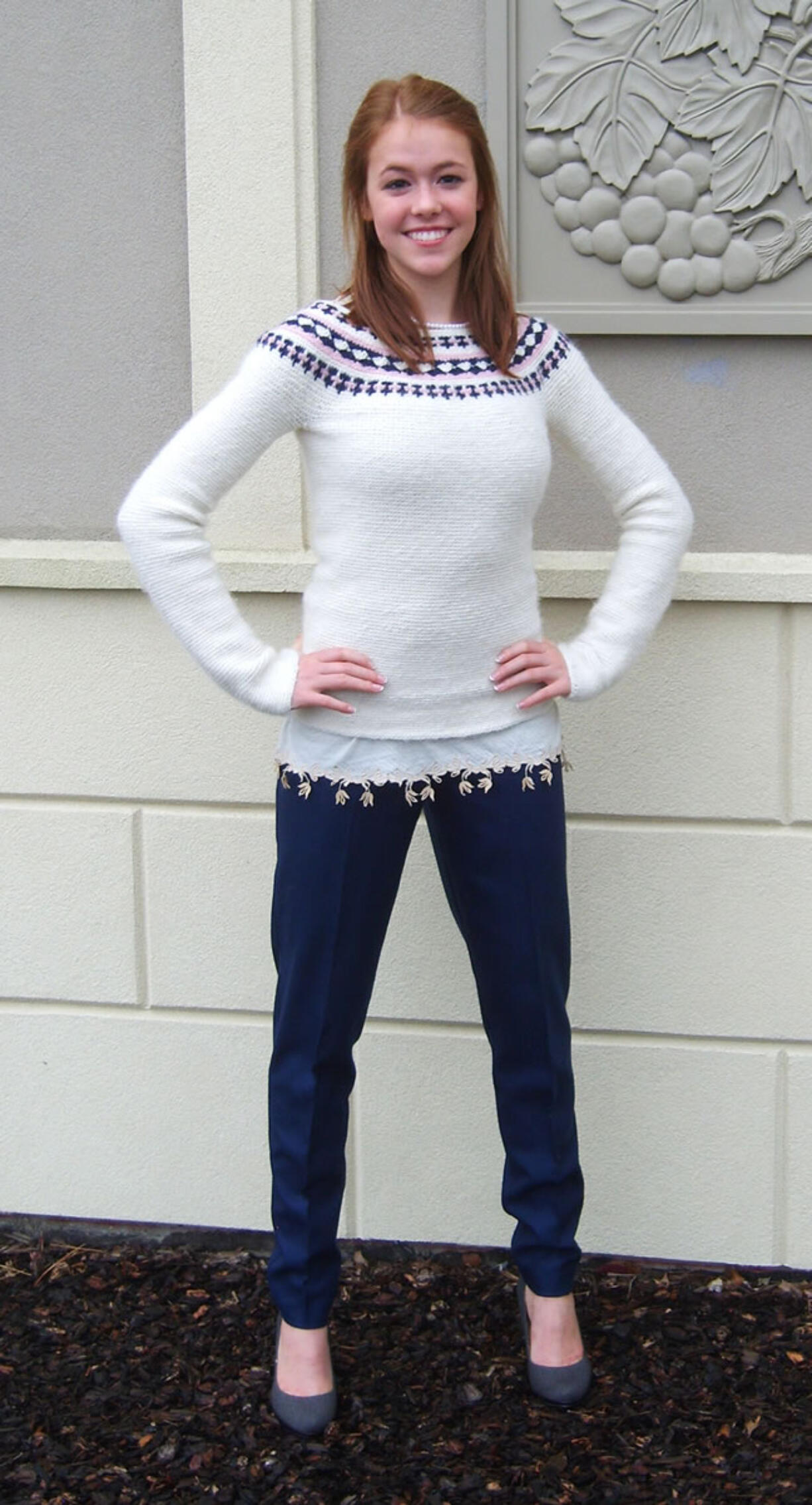 Clark County: Heidi Christenson, 19, of Ridgefield models the cream, navy and pink crocheted woolen sweater, cream knit camisole and navy slacks she entered in the Washington State Make It With Wool competition, for which she won the senior division.