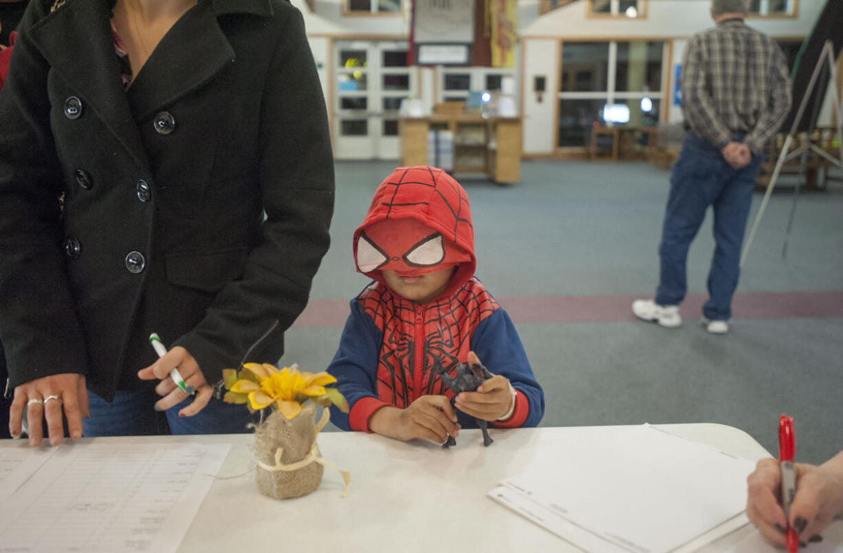 Rimany Samoeum, 4, gets checked in with his family at St. Andrew Lutheran Church in east Vancouver near Orchards. The church will be used as a temporary overnight shelter until the end of March.