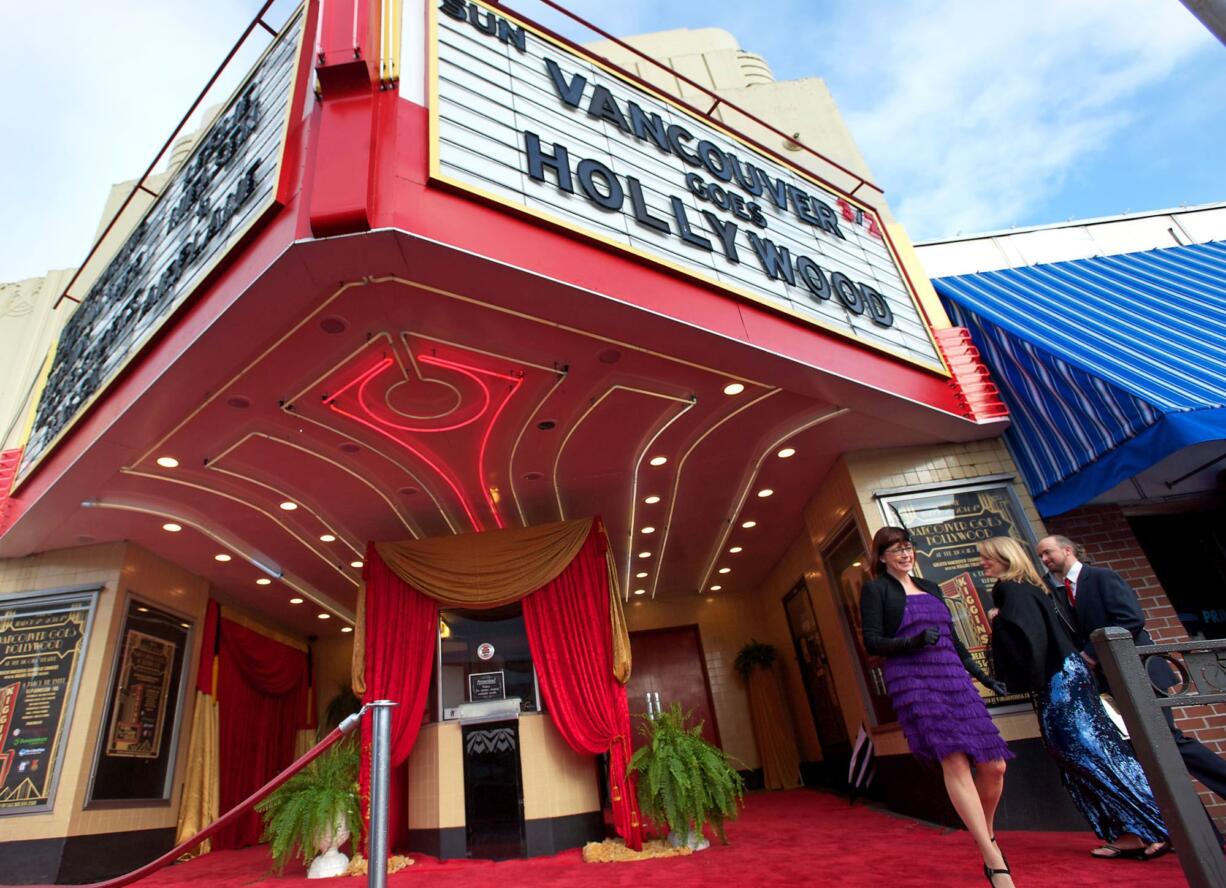 Greater Vancouver Chamber of Commerce President and CEO Kelly Parker walks toward Main Street as Braden and Amy Hurt of Vancouver arrive at the Academy Awards viewing party at Kiggins Theatre.