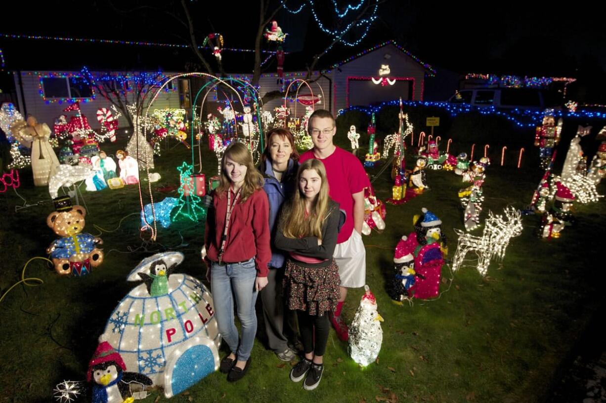 The Nortz family, from left, Mikaila, 16, Rene, Rheanna, 12, and Logan, 18, stand outside their Ogden neighborhood home on December 10. Rene Nortz, who calls her holiday display &quot;The Nortz Pole&quot; has an assortment of decorations. She starts getting out her lights the day after Halloween.