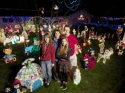 The Nortz family, from left, Mikaila, 16, Rene, Rheanna, 12, and Logan, 18, stand outside their Ogden neighborhood home on December 10. Rene Nortz, who calls her holiday display &quot;The Nortz Pole&quot; has an assortment of decorations. She starts getting out her lights the day after Halloween.