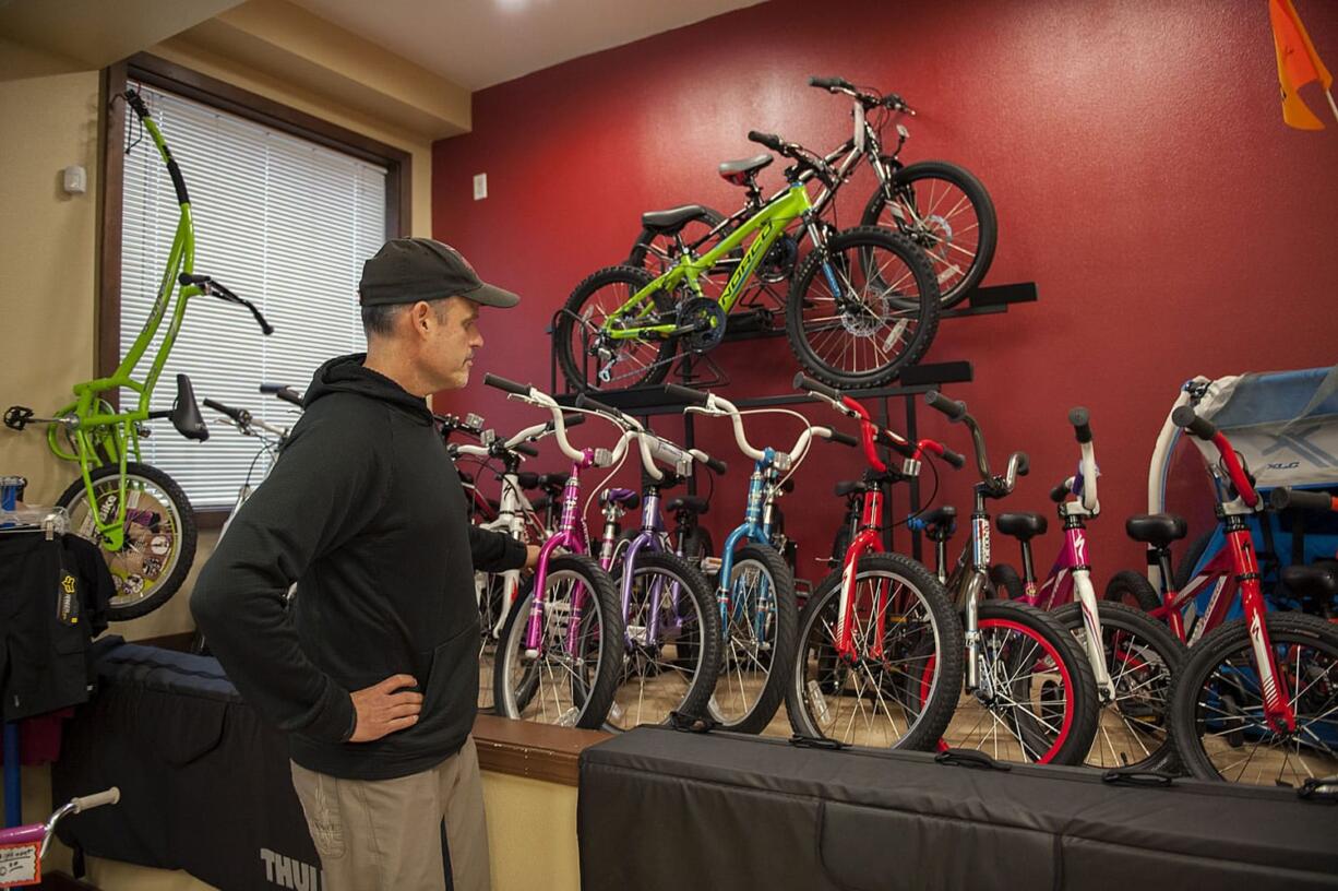 Ed Fischer, owner of Camas Bike and Sport, looks over a selection of kids bikes that he says make good Christmas gifts.