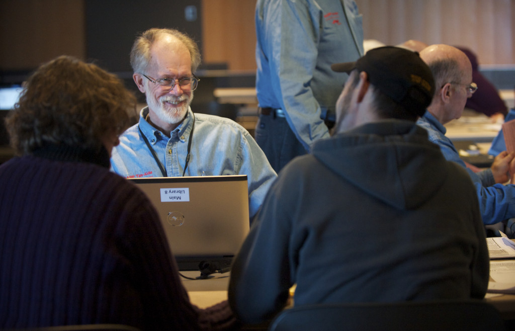 Volunteer Tax Aide Rich Watters greets Judy and Michael Johnson before digging into their taxes at the Vancouver Community Library in 2015..