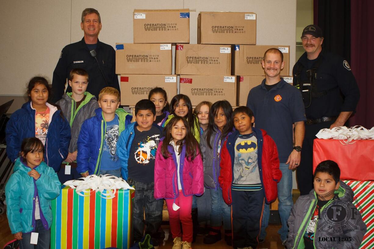 Hazel Dell: Firefighters from Clark County Fire District 6's IAFF Local 1805 union and some of the kids who received new winter coats from the union's participation in Operation Warm.