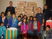 Hazel Dell: Firefighters from Clark County Fire District 6's IAFF Local 1805 union and some of the kids who received new winter coats from the union's participation in Operation Warm.