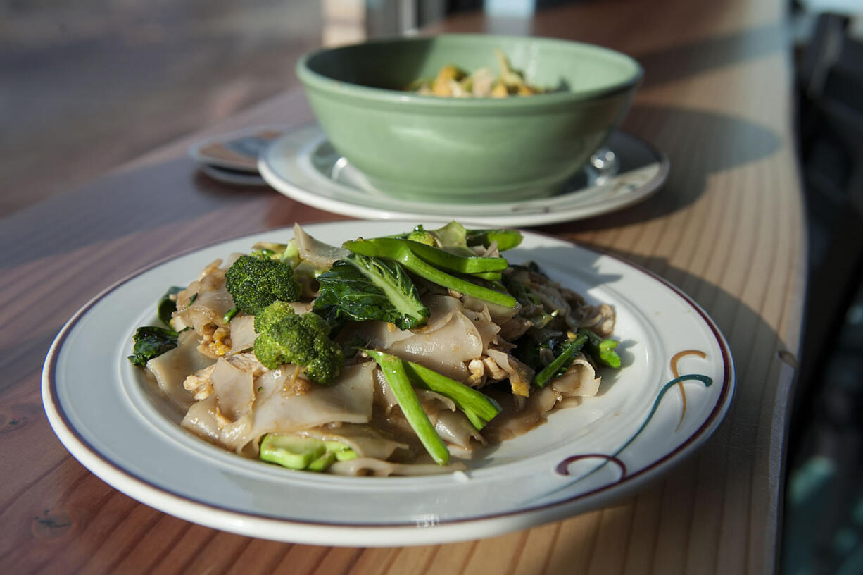 A plate of pad see ew and a bowl of Evil Prince from the E-San Thai food cart shown Friday at Tap Door Brewing in Vancouver.