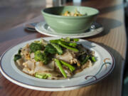 A plate of pad see ew and a bowl of Evil Prince from the E-San Thai food cart shown Friday at Tap Door Brewing in Vancouver.