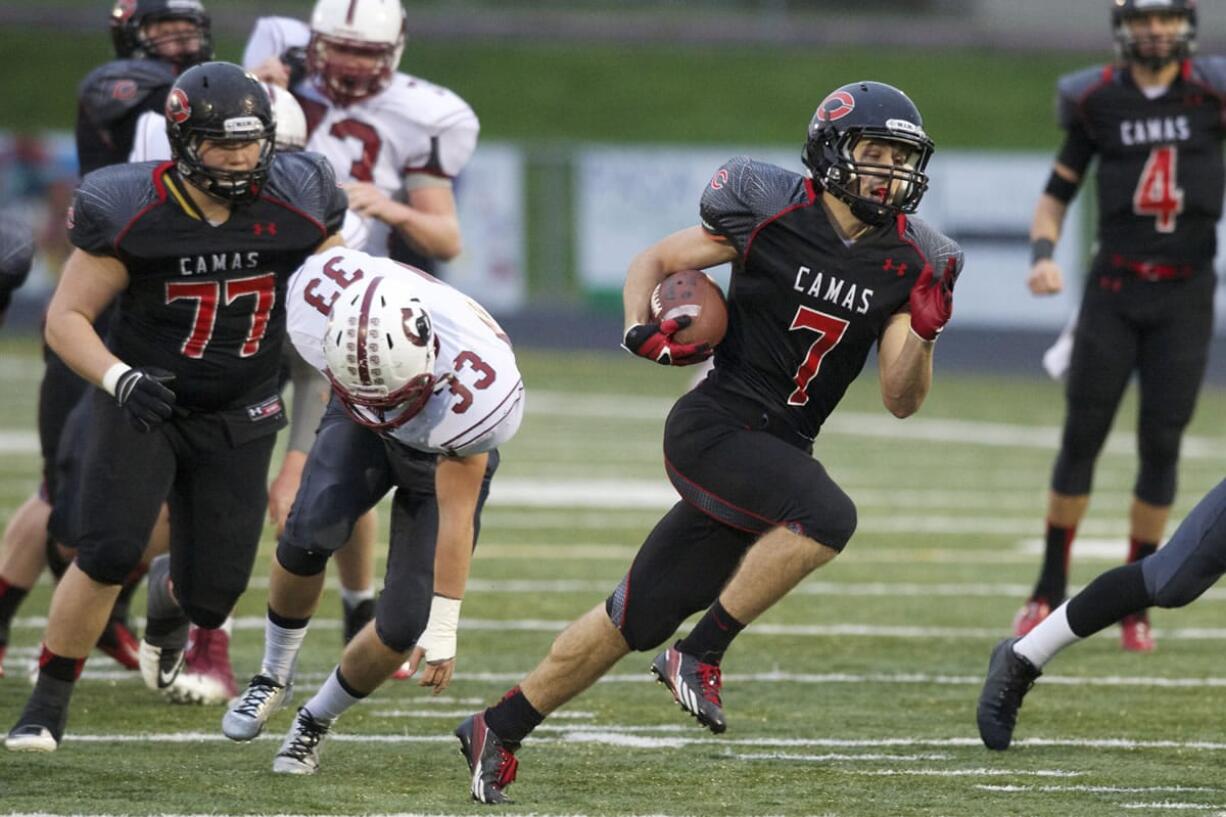 Camas running back Nate Beasley carries the ball against Cascade at Doc Harris Stadium, Saturday, November 16, 2013. Beasley scored five touchdowns in a 63-28 win over Cascade.