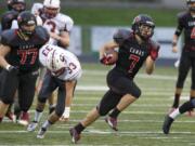 Camas running back Nate Beasley carries the ball against Cascade at Doc Harris Stadium, Saturday, November 16, 2013. Beasley scored five touchdowns in a 63-28 win over Cascade.