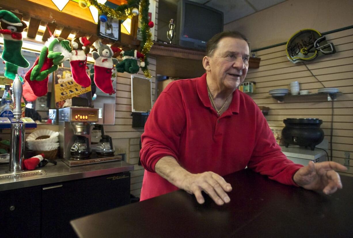 Chuck Chronis issues orders to the troops before opening the doors for visitors coming for his restaurant's free Christmas meal.