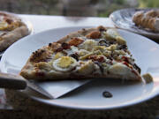 Two slices of Mediterranean pizza are served Nov. 3 next to a plate of cannoli at Vinnie&#039;s Pizza in downtown Vancouver.