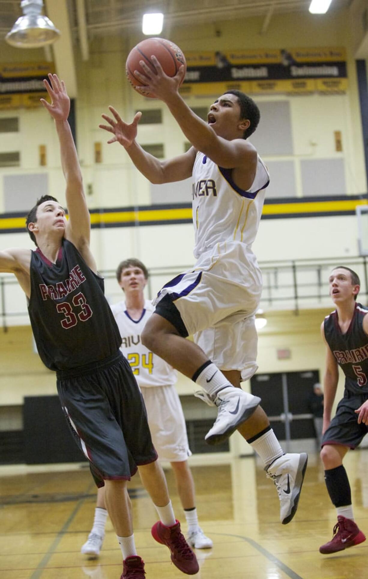 Columbia River's Nathan Hawthorne drives to the basket against Prairie at the 3A Boys District Tournament at Hudson's Bay High School, Friday, February 14, 2014.