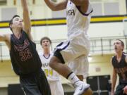 Columbia River's Nathan Hawthorne drives to the basket against Prairie at the 3A Boys District Tournament at Hudson's Bay High School, Friday, February 14, 2014.