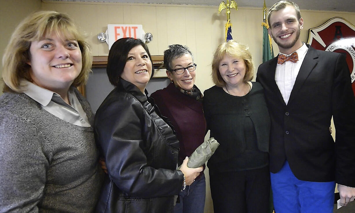 Supporters of Anne McEnerny-Ogle stand for photos during a swearing-in event Wednesday at the Vancouver Fire Fighters Hall in Vancouver.