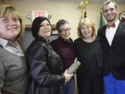 Supporters of Anne McEnerny-Ogle stand for photos during a swearing-in event Wednesday at the Vancouver Fire Fighters Hall in Vancouver.