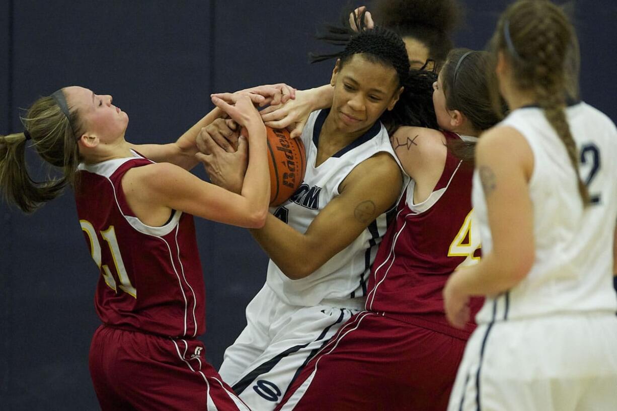 Jocelyn Adams, center, of Skyview  fights for a rebound against Jamie Phares, left, and Jordan Adams, right, of Prairie on Tuesday.