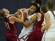 Jocelyn Adams, center, of Skyview  fights for a rebound against Jamie Phares, left, and Jordan Adams, right, of Prairie on Tuesday.