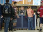 Vancouver School District Resource Officer Alex Wright keeps watch on students from a security kiosk just inside the main doors at Skyview High School.