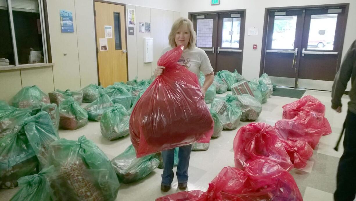 Evergreen High School: Sea Mar nurse manager Lynn Smiley bundles presents before the big party Dec.