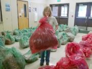 Evergreen High School: Sea Mar nurse manager Lynn Smiley bundles presents before the big party Dec.