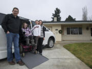 Eric, 12-year-old Emily, 7-year-old Daniel and Triann Benson smile about the new addition to their Minnehaha-area household: a specially retrofitted Toyota Sienna minivan. An anonymous donor made the $25,000 down payment on the customized $75,000 vehicle, which will allow Emily's parents to take her with them when they go on trips short and long -- just like any other kid.