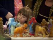 Lily Bowler, 4, of Vancouver looks at nativities from around the world Sundayat the Festival of Nativities.