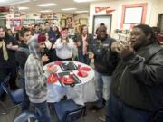 Jose Scott, 18, right, a senior at Fort Vancouver High School, learns to sing the Washington State University fight song with other seniors.