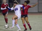 Camas' Anyssa De Vera, right, battles for the ball with Issaquah's Catey Nelson during action in the 4A state girls soccer semifinals in Puyallup.